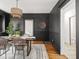 Elegant dining room with black walls, a woven chandelier, and seating for six at 3936 Graceland Ave, Indianapolis, IN 46208