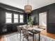 Dining room with black walls, bright windows, stylish rug, and seating for four at 3936 Graceland Ave, Indianapolis, IN 46208