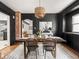 Dining room with black walls, red brick, and a woven light fixture at 3936 Graceland Ave, Indianapolis, IN 46208