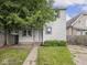 Charming home exterior with green lawn, mature trees, and a welcoming front porch at 3936 Graceland Ave, Indianapolis, IN 46208