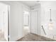 Bright upstairs hallway that leads into a carpeted bedroom and features a small seating area at 3936 Graceland Ave, Indianapolis, IN 46208