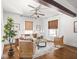 Open-concept living room featuring hardwood floors, beamed ceilings, and natural light at 3936 Graceland Ave, Indianapolis, IN 46208