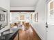 Open-concept living room with hardwood floors, ceiling fan, and ample natural light at 3936 Graceland Ave, Indianapolis, IN 46208
