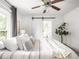 Well-lit primary bedroom with a modern ceiling fan and sliding barn door at 3936 Graceland Ave, Indianapolis, IN 46208