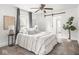 Comfortable primary bedroom features a sliding barn door, a ceiling fan, and large windows at 3936 Graceland Ave, Indianapolis, IN 46208
