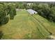 An aerial view of the expansive acreage, featuring green pastures and multiple outbuildings at 3942 Senour Rd, Indianapolis, IN 46239