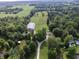 Picturesque aerial shot showcasing the property's layout, including the buildings, driveway, and lush surroundings at 3942 Senour Rd, Indianapolis, IN 46239