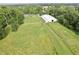 Large manicured property with white fences and various trees, including a home and barn at 3942 Senour Rd, Indianapolis, IN 46239