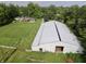 Spacious property featuring a large metal building, house, and meticulously maintained green spaces at 3942 Senour Rd, Indianapolis, IN 46239
