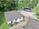 Aerial view showcasing an RV parked on a gravel area and house with lush trees surrounding the property at 3942 Senour Rd, Indianapolis, IN 46239
