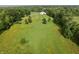 A lovely aerial view of the property, including lush green grass and a large barn surrounded by many trees at 3942 Senour Rd, Indianapolis, IN 46239