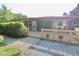 Back porch with a sliding door and seating area, landscaped with plants and rock at 3942 Senour Rd, Indianapolis, IN 46239