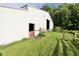 Exterior view of the barn, featuring a pasture gate and ample greenery at 3942 Senour Rd, Indianapolis, IN 46239