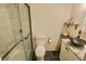 Modern bathroom with a glass-enclosed shower, toilet, and vanity with a unique vessel sink at 3942 Senour Rd, Indianapolis, IN 46239