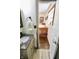 View from bathroom into charming bedroom with a wooden bed frame and window at 3942 Senour Rd, Indianapolis, IN 46239