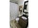 Cozy bathroom featuring a vanity with a dark countertop and a shower with a decorative curtain at 3942 Senour Rd, Indianapolis, IN 46239
