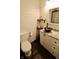 Updated bathroom featuring a wood sink, granite countertops, and a new toilet at 3942 Senour Rd, Indianapolis, IN 46239