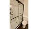 Bathroom featuring a shower with a glass door, white subway tile, and a new toilet at 3942 Senour Rd, Indianapolis, IN 46239