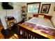 Bright bedroom with a wood bed frame, plush bedding, and dark wood flooring at 3942 Senour Rd, Indianapolis, IN 46239