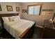 Cozy bedroom with a dark wood bed frame, matching dresser, and a window that provides natural light at 3942 Senour Rd, Indianapolis, IN 46239