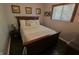 Cozy bedroom with a dark wood bed frame, matching dresser, and a window that provides natural light at 3942 Senour Rd, Indianapolis, IN 46239