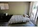 Relaxing bedroom featuring hardwood floors, a queen size bed, and a sliding glass door at 3942 Senour Rd, Indianapolis, IN 46239