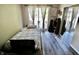This bedroom features a twin bed, wood floors, sliding glass doors, and mirrored closet doors at 3942 Senour Rd, Indianapolis, IN 46239