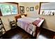 Inviting bedroom with a wood bed frame, warm-toned walls, and a sunny window at 3942 Senour Rd, Indianapolis, IN 46239
