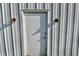A white door on the side of the barn, with two vintage lights on either side at 3942 Senour Rd, Indianapolis, IN 46239
