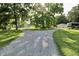 Gravel driveway splits, leading to a garage and RV parked on the grassy property at 3942 Senour Rd, Indianapolis, IN 46239