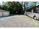 Long driveway with large RV, leading to the house, a basketball court, and separate garage at 3942 Senour Rd, Indianapolis, IN 46239