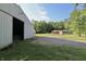 The exterior of the property shows a barn, house, and driveway with landscaping, flowers, and tall trees at 3942 Senour Rd, Indianapolis, IN 46239