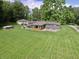 Aerial view of home featuring a patio, attached garage, and large lot at 3942 Senour Rd, Indianapolis, IN 46239