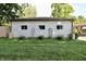 View of the back of the house with charming planters and water barrels, set in a lush green yard at 3942 Senour Rd, Indianapolis, IN 46239