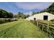 Expansive yard and barn with fenced pastures on a sunny day at 3942 Senour Rd, Indianapolis, IN 46239