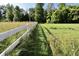 A wooden fence running along the property line, with green grass and trees creating a natural barrier at 3942 Senour Rd, Indianapolis, IN 46239