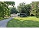 RV parked on the grassy property, with a garage, an American flag, and trees in the background at 3942 Senour Rd, Indianapolis, IN 46239