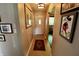Inviting hallway featuring tiled flooring, artwork, and a white front door that fills the space with natural light at 3942 Senour Rd, Indianapolis, IN 46239