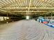 Large indoor arena with tractor and ample space, perfect for riding, training, or events, with ample lighting at 3942 Senour Rd, Indianapolis, IN 46239