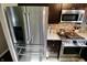 Close-up of stainless steel refrigerator, microwave, and stove, showcasing the kitchen's updated appliances at 3942 Senour Rd, Indianapolis, IN 46239