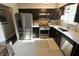 Modern kitchen with stainless steel appliances, dark cabinets, and white countertops creating a sleek design at 3942 Senour Rd, Indianapolis, IN 46239