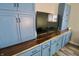 Living room featuring a built-in blue wall unit with wooden countertops at 3942 Senour Rd, Indianapolis, IN 46239