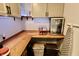 Pantry showcasing wooden countertops, storage cabinets with lighting, and snack storage at 3942 Senour Rd, Indianapolis, IN 46239