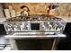 Modern stainless steel gas range with digital display and stone backsplash at 3942 Senour Rd, Indianapolis, IN 46239