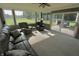 Bright sunroom with ceiling fan, carpet, and lots of windows overlooking the yard at 3942 Senour Rd, Indianapolis, IN 46239