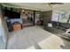 Bright sunroom with ceiling fan, carpet, and lots of windows overlooking the yard and open to dining area at 3942 Senour Rd, Indianapolis, IN 46239