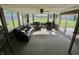 Bright sunroom with ceiling fan, carpet, and lots of windows overlooking the yard at 3942 Senour Rd, Indianapolis, IN 46239
