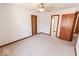 Spacious bedroom featuring neutral carpet and multiple doors, some leading to additional rooms at 3948 S Woodfield Dr, New Palestine, IN 46163