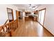 Open-concept living area showcasing hardwood flooring and abundant natural light from the windows at 3948 S Woodfield Dr, New Palestine, IN 46163