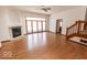 Bright living room with hardwood floors, a fireplace, and access to the deck through large glass doors at 3948 S Woodfield Dr, New Palestine, IN 46163
